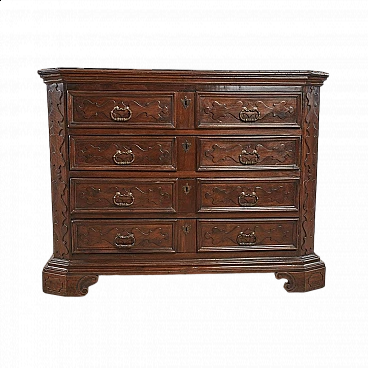 Four-drawer wooden chest of drawers with carved decorations in relief, 17th century