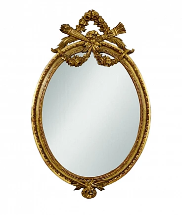 Louis XVI style oval carved and gilded wood mirror, 19th century