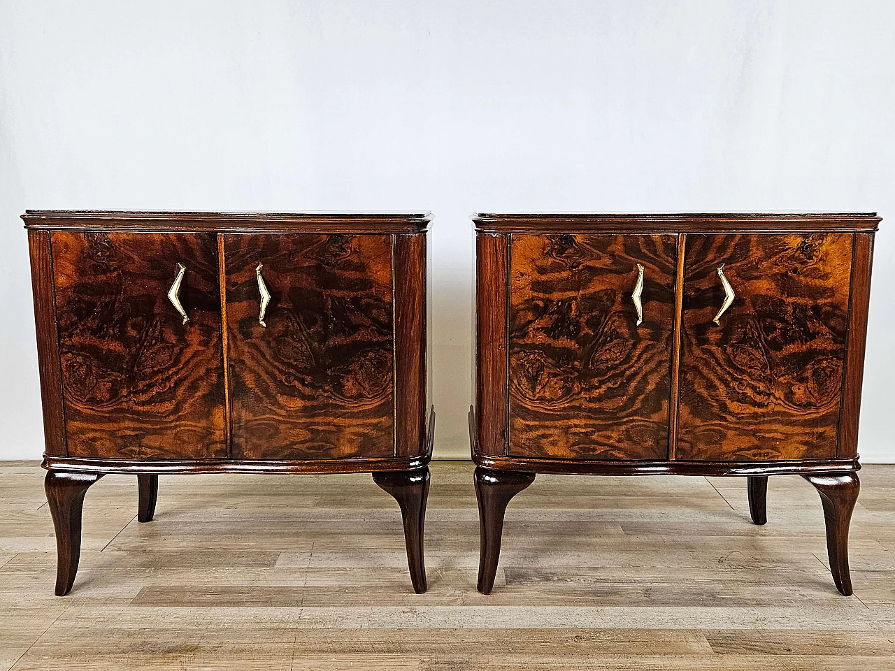 Pair of walnut bedside tables with brass handles and wavy legs, 1950s 1