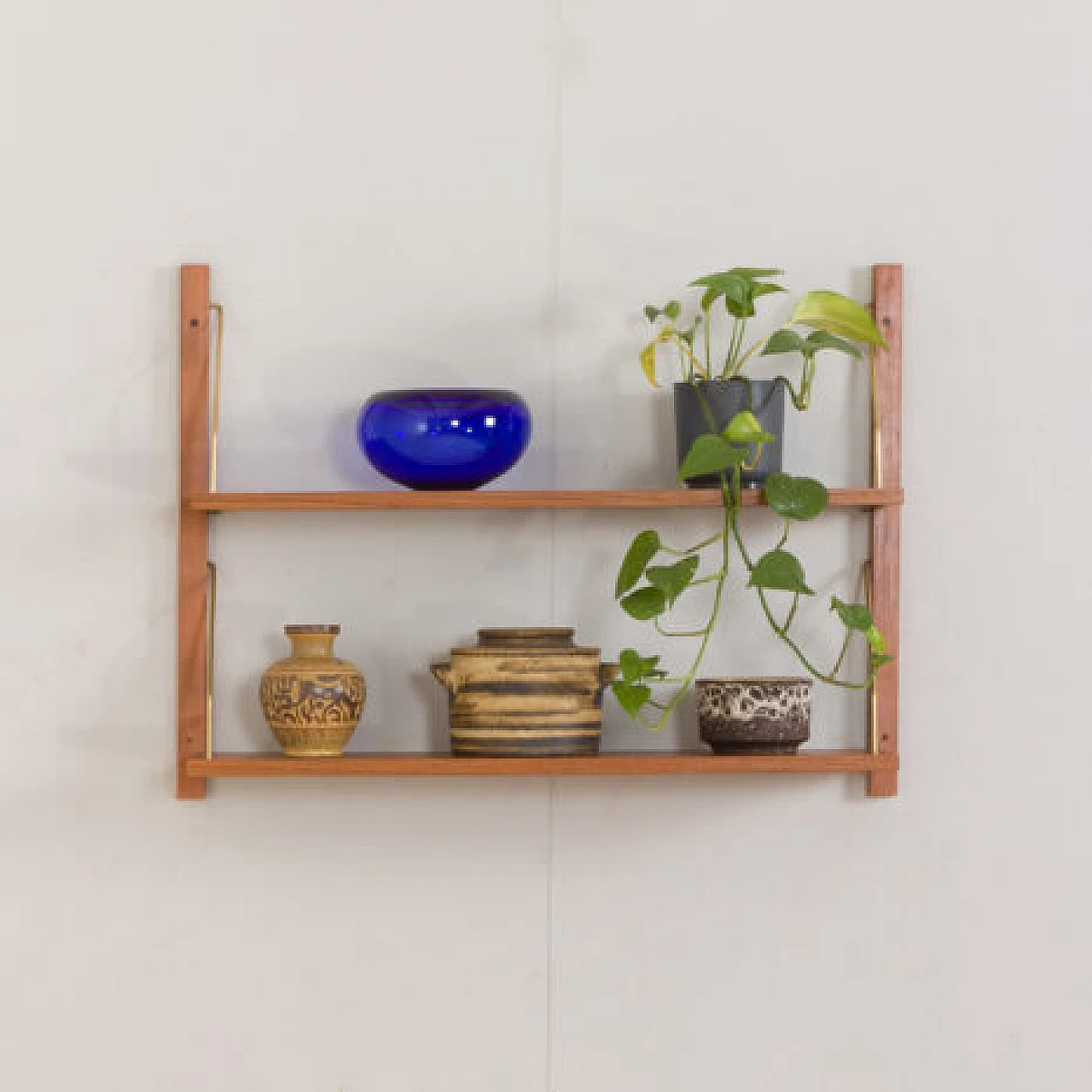 Hanging teak and brass bookcase in the style of Poul Cadovius, 1970s 1