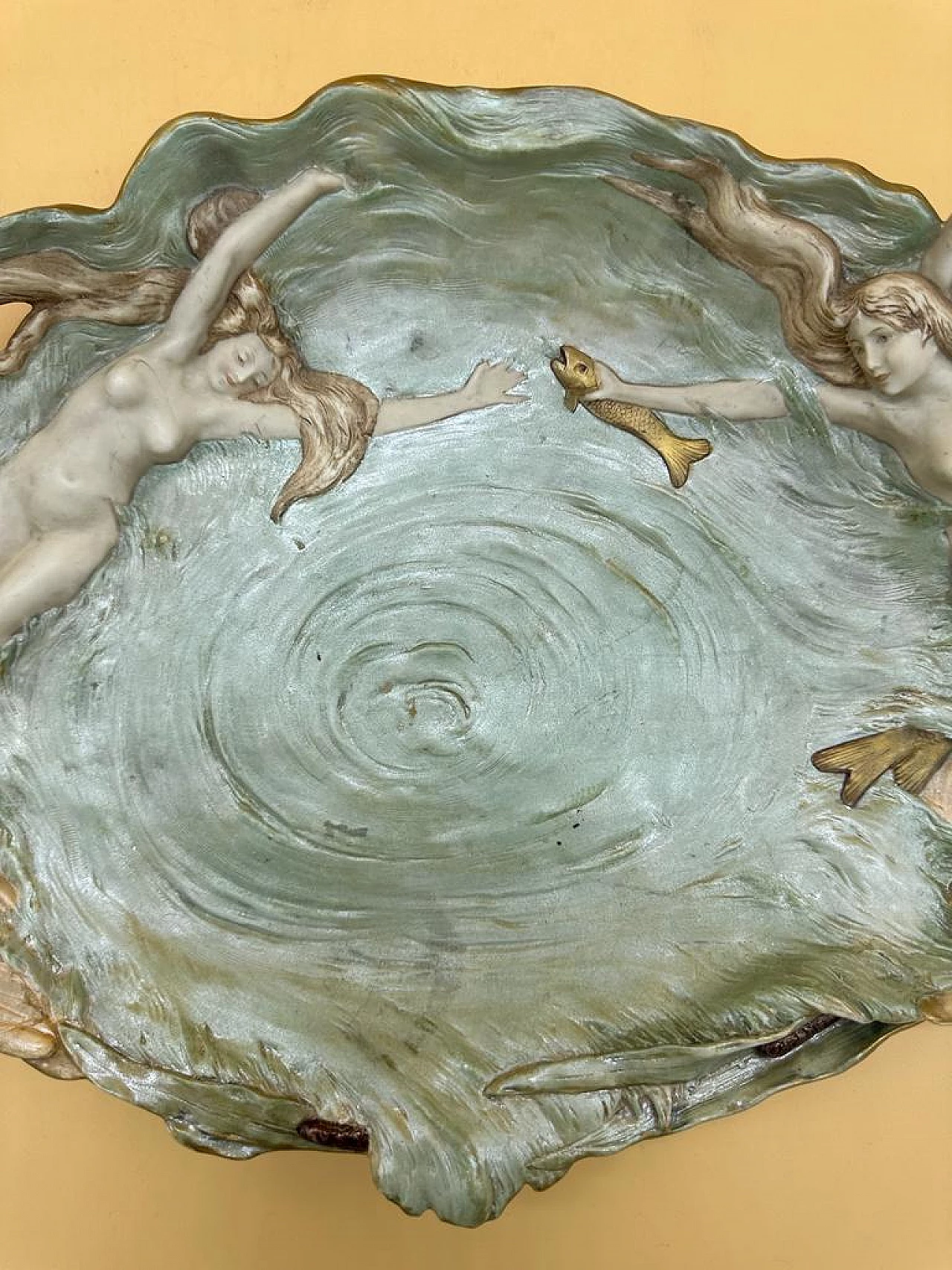 Oval ceramic bas-relief with two mermaids, fish and two swan handles, early 20th century 1