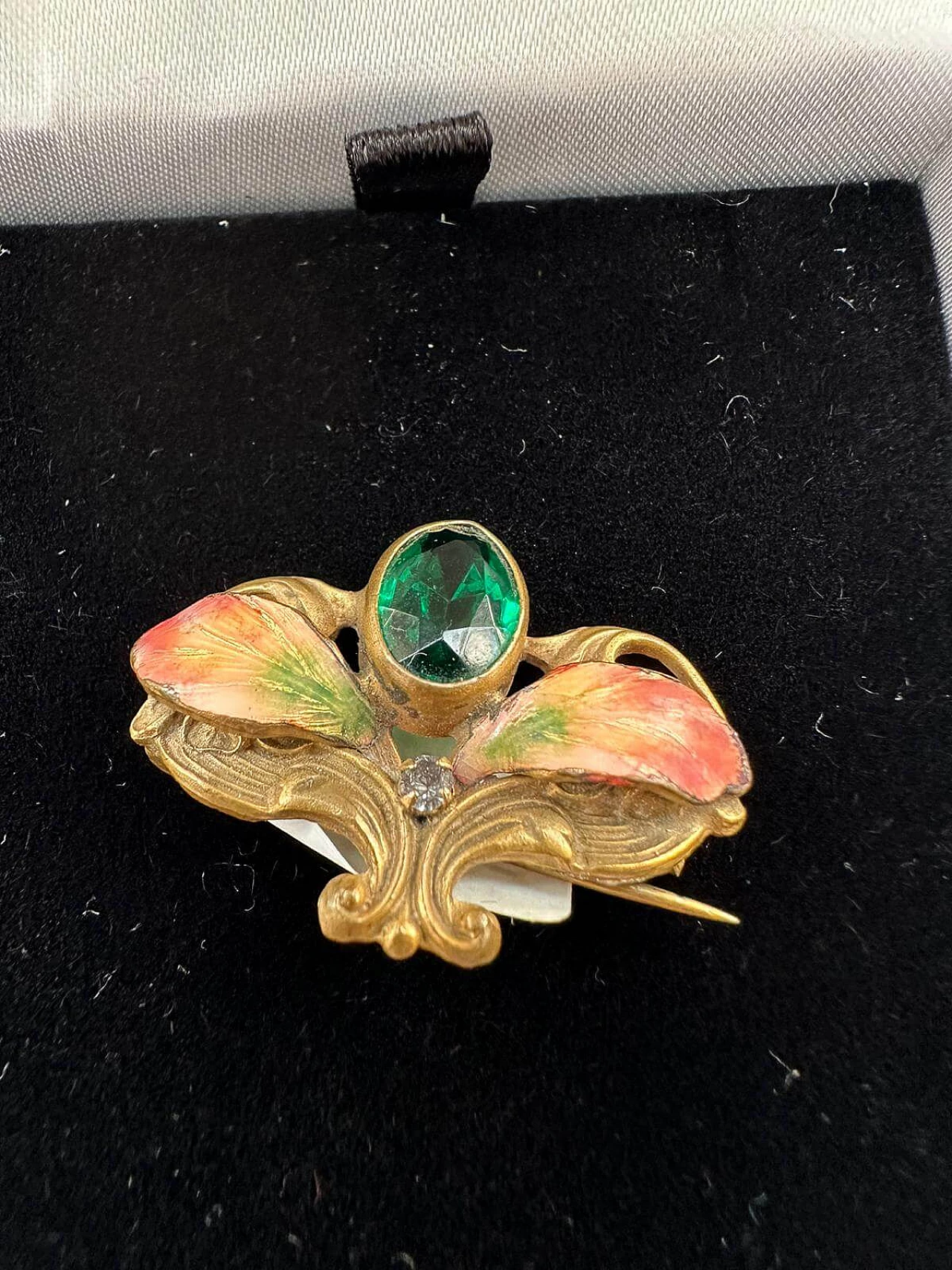 Gold-plated metal brooch with green stones, glitter and enamel leaves, early 1900s 1