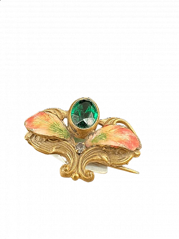 Gold-plated metal brooch with green stones, glitter and enamel leaves, early 1900s