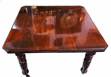 English mahogany extendable table with casters, late 19th century