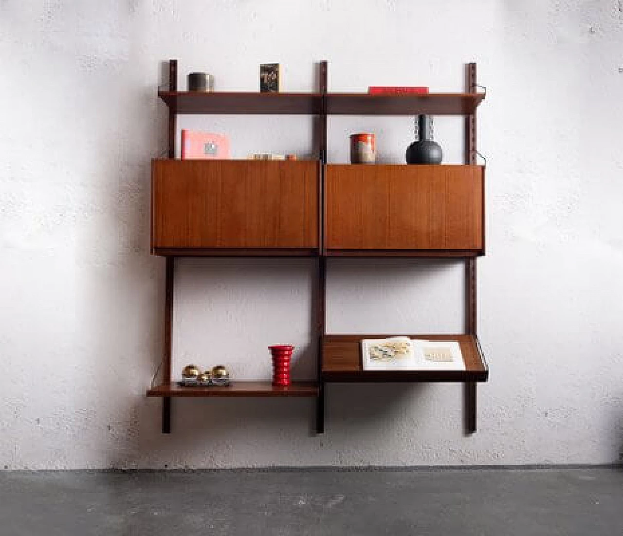 Wall-mounted teak and brass bookcase, 1960s 11