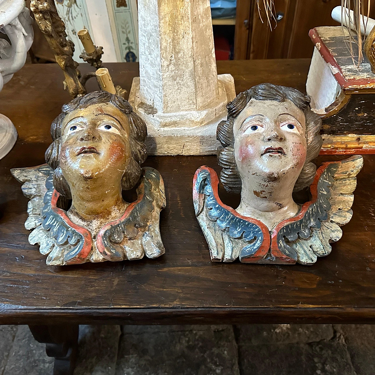 Angel heads, pair of lacquered wood sculptures, mid-18th century 19