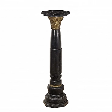 Black marble column in neoclassical style with bronze details