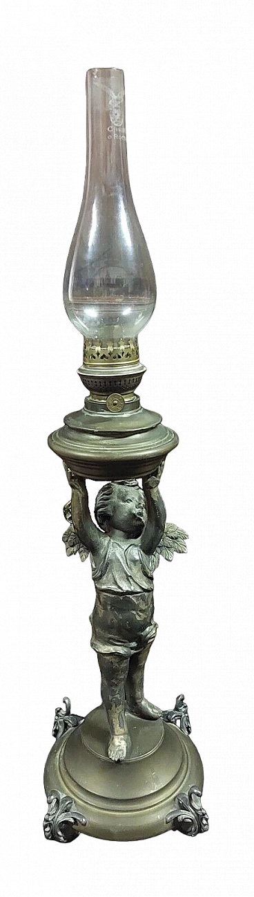 Antimony and brass oil lamp with winged putto, 19th century