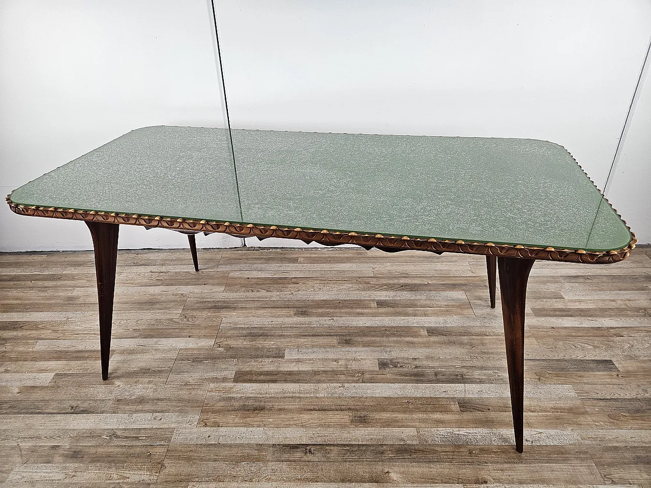 Table in carved wood with decorated green glass top, 60s 1